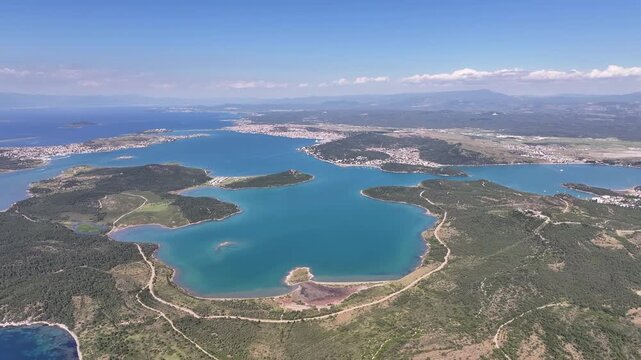 Aerial footage flying over the beautiful coastline and turquoise sea of Ayvalik in Turkey, oe01