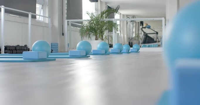 Micro dolly moving is revealing row of blue balls on foam blocks and mats, prepping studio