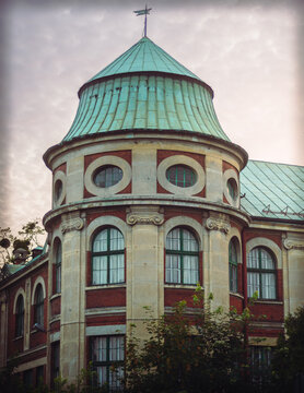 Historic building architecture with a round tower and green copper roof