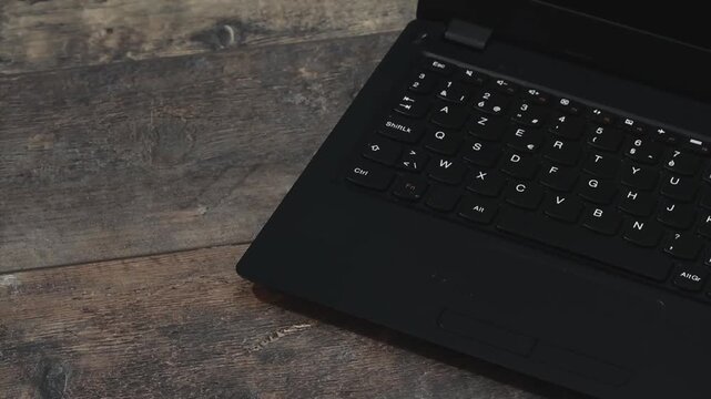 Open laptop and put on wireless headphones to start work at home office