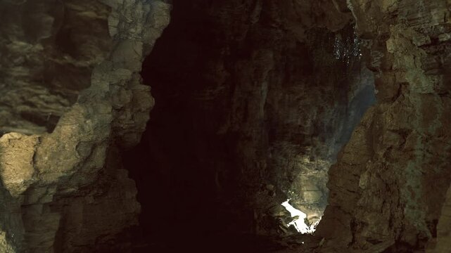 Dim cavern with single light, mossy rock edges and still water reflecting faint glow, deep shadows, cool damp atmosphere, isolated exploration vibe ideal