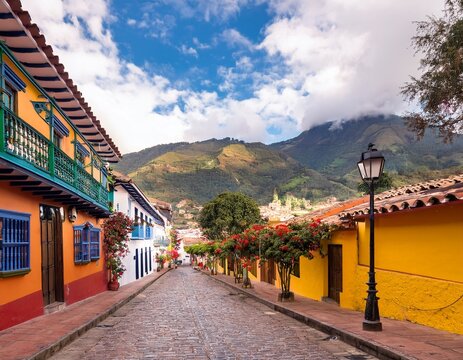 historic cobblestone streets and vibrant colonial architecture of candelaria neighborhood in bogota colombia surrounded by majestic andean mountains and lush greenery