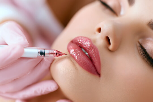 Permanent makeup artist applying lip pigment with microblading needle, sterile clinical setting