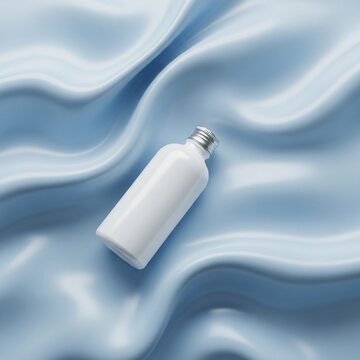 A mockup of a white skincare product bottle lies on a wavy blue fabric surface for a product advertisement photo.