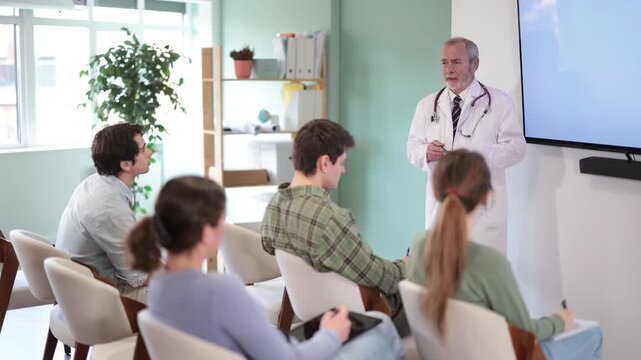 Qualified male doctor gives a lecture to university students. High quality 4k footage