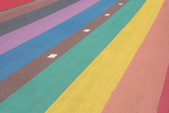 Colorful striped road surface with white markings