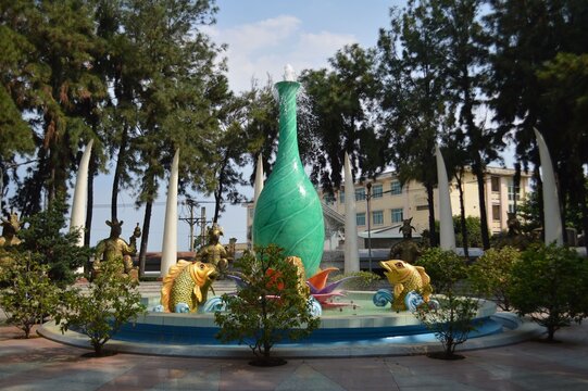Colorful fountain with horse sculptures in a park