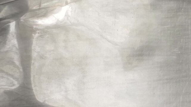 Crumpled Transparent Plastic Wrap Texture with Wrinkled Surface and Light Reflections