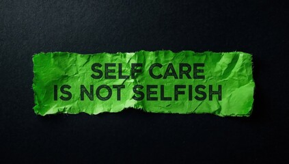 Obraz premium Message about self-care on tattered green paper against a dark backdrop. Symbol of self-care being unselfish. Room for text.