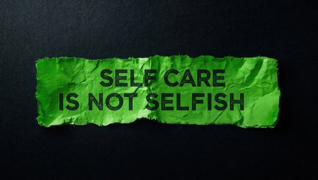 Message about self-care on tattered green paper against a dark backdrop. Symbol of self-care being unselfish. Room for text.