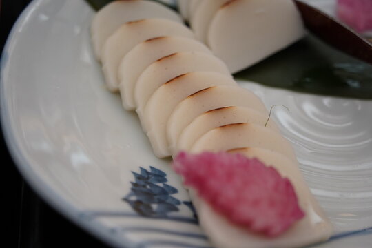 Sliced Japanese kamaboko fish cake on a ceramic plate