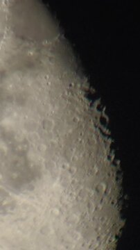 Highly magnified view of the lunar surface with detailed craters along the terminator