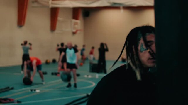 Fit Male Leads Fitness Class in Gym