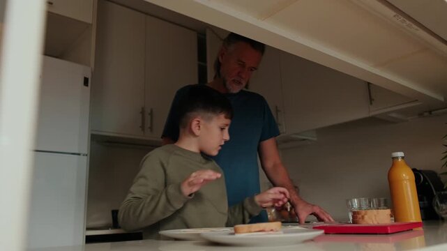 Father and Son Making Sandwiches Together in the Kitchen