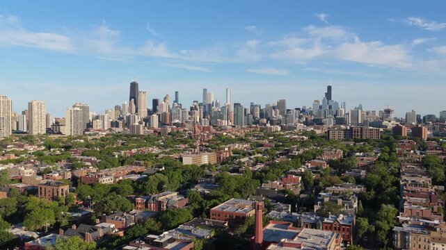 Iconic Chicago skyline highlighting Willis Tower and John Hancock Center from neighborhood with residential streets, green trees, and historic architecture