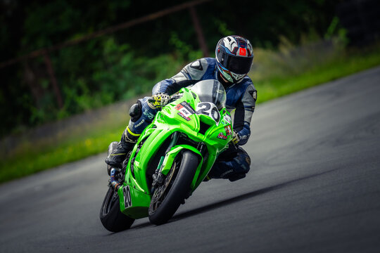 Regular training in Riga, Latvia, Bikernieki on 12-05-2026  Motocross Rider on Green Motorcycle in Action