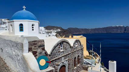 Fototapeta premium Imerovigli village with blue dome church overlooking caldera