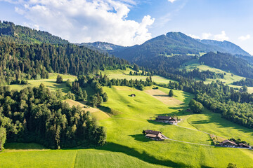 Drone panorama of rolling green pastures and traditional chalets in Erlenbach im Simmental - Canton of Bern, Switzerland © Carismarkus