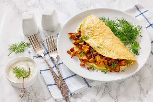 Egg omelet with fried wild chanterelles and dill