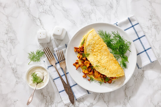 Egg omelet with fried wild chanterelles and dill