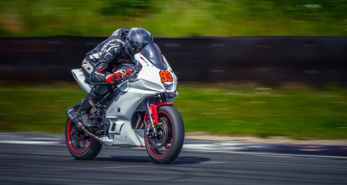Regular training in Riga, Latvia, Bikernieki on 12-05-2026  Motorcycle racer leaning into a turn on racetrack