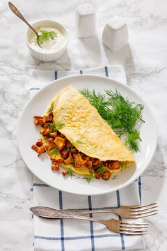 Egg omelet with fried wild chanterelles and dill