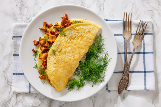 Egg omelet with fried wild chanterelles and dill