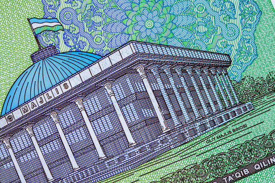 A 5000 Uzbek soum banknote. The reverse side depicts the parliament building in Tashkent, and the obverse side depicts the national emblem of the Republic of Uzbekistan.