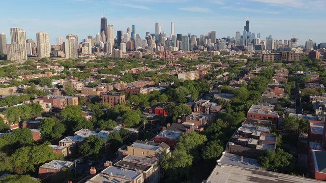 Cinematic aerial flight over residential neighborhood showing Chicago's skyline, including Willis Tower and John Hancock Center in a sunny summer day in Illinois