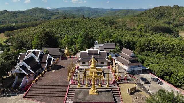 Aerial view of Buddhist pagoda named Wat Phra That Mok Mung Mueang located in Thoeng district of Chiang Rai province of Thailand.