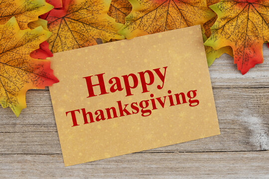 Happy Thanksgiving message card with autumn leaves