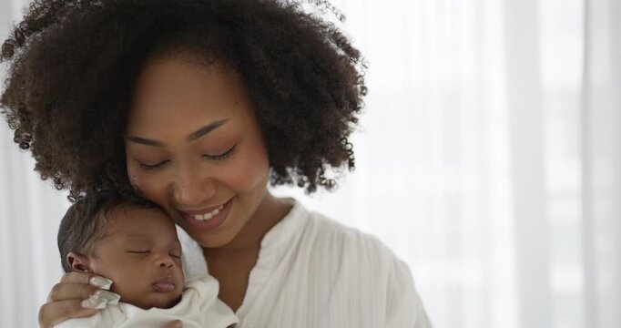 Close up portrait of beautiful young African American mother holding sleep newborn baby in hospital. Healthcare medical love black afro woman lifestyle mother's day, breast concept 