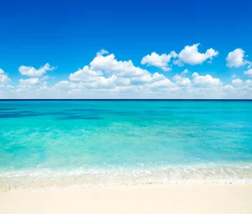 Beach and beautiful tropical sea. Blue sky and white clouds. © Pakhnyushchyy