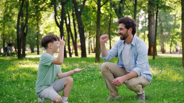 Happy father enjoys playful competition with cheerful son