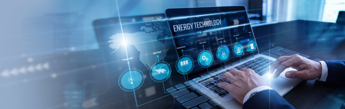 Power engineer calculating metrics using laptop monitoring smart Energy Technology grids on a detailed virtual screen schematic. Renewable resource optimization and efficient grid networks.
