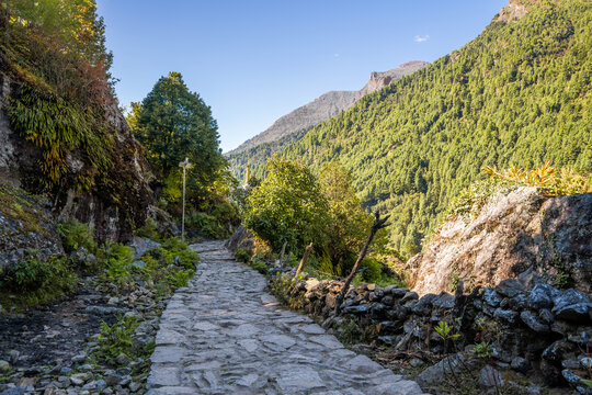 A wide, flat, stone-paved trekking route near Lukla. Everest base camp trek in Himalaya mountains in Nepal.