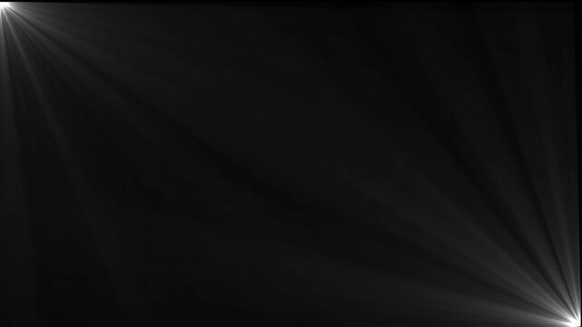 Bright white light source in the left corner casting diagonal rays across a solid black background for a dramatic lighting effect