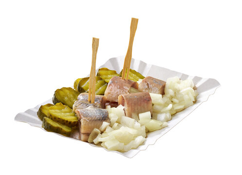 typical dutch snack with herring, pickles and onion in paper tray isolated on white background. Authentic Dutch herring snack in paper tray isolated on white background.