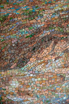 Colorful mosaic pattern with ceramic fragments on concrete surface