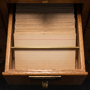 Blank index card in vintage library card catalog drawer