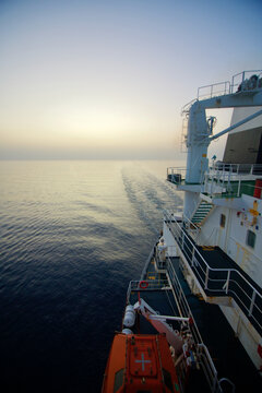 View of the stern of a merchant ship at sea in the morning