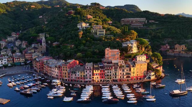 Portofino drone view, flying above Portofino harbour with luxury yachts and sailboats at sunrise, port and bay of Portofino on Ligurian coast, holidays on Italian Riviera