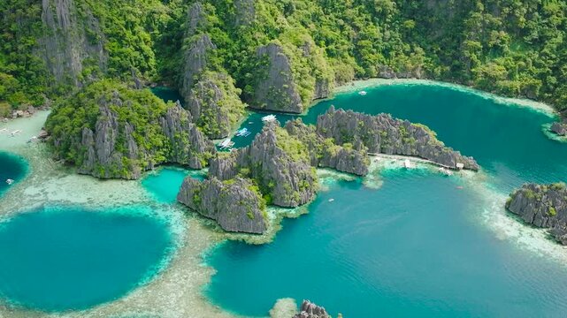 Green Lagoon and Twin Lagoon with tourist boats and limestone rocks. Coron, Palawan. Philippines.