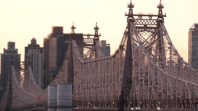 New York City Manhattan Midtown skyline from Queens, Queensboro bridge architecture, United States. Cityscape from rooftop in Long Island, Hunters Point. Urban sunset over transport metallic bridge.