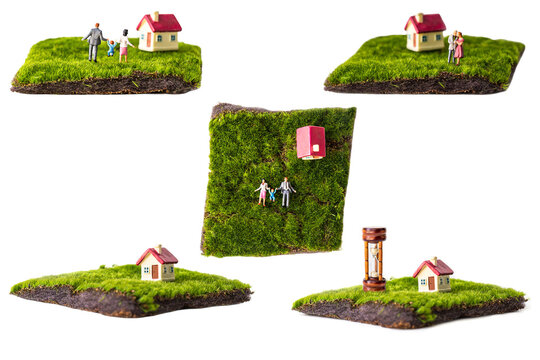 miniature couple and miniature house with red roof on green grass isolated on white background.
