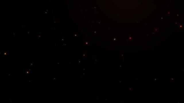 Magical fiery glowing embers slowly ascending in a dark mysterious atmospheric background video