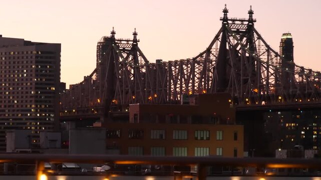 New York City Manhattan Midtown skyline from Queens, Queensboro bridge architecture, United States. Cityscape from rooftop in Long Island, Hunters Point. Light bulbs garland on roof, urban sunset.