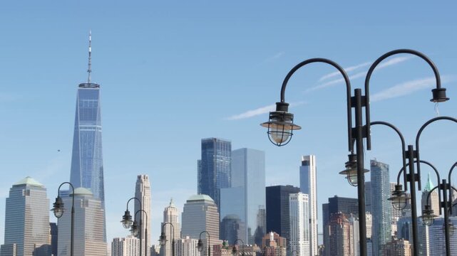 New York City Manhattan Downtown Financial District skyline, World Trade Center tower from New Jersey Liberty state park, United States. Pier lantern lamps and urban cityscape, skyscraper buildings.