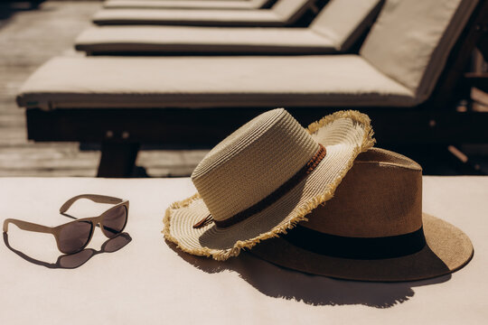 Straw hats and sunglasses resting on a sunbed