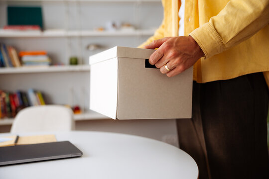 Person Holding Cardboard Box 